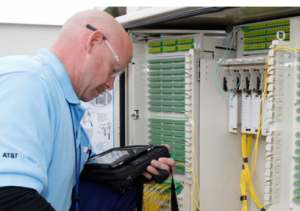 An AT&T fiber technician installing office connection.
